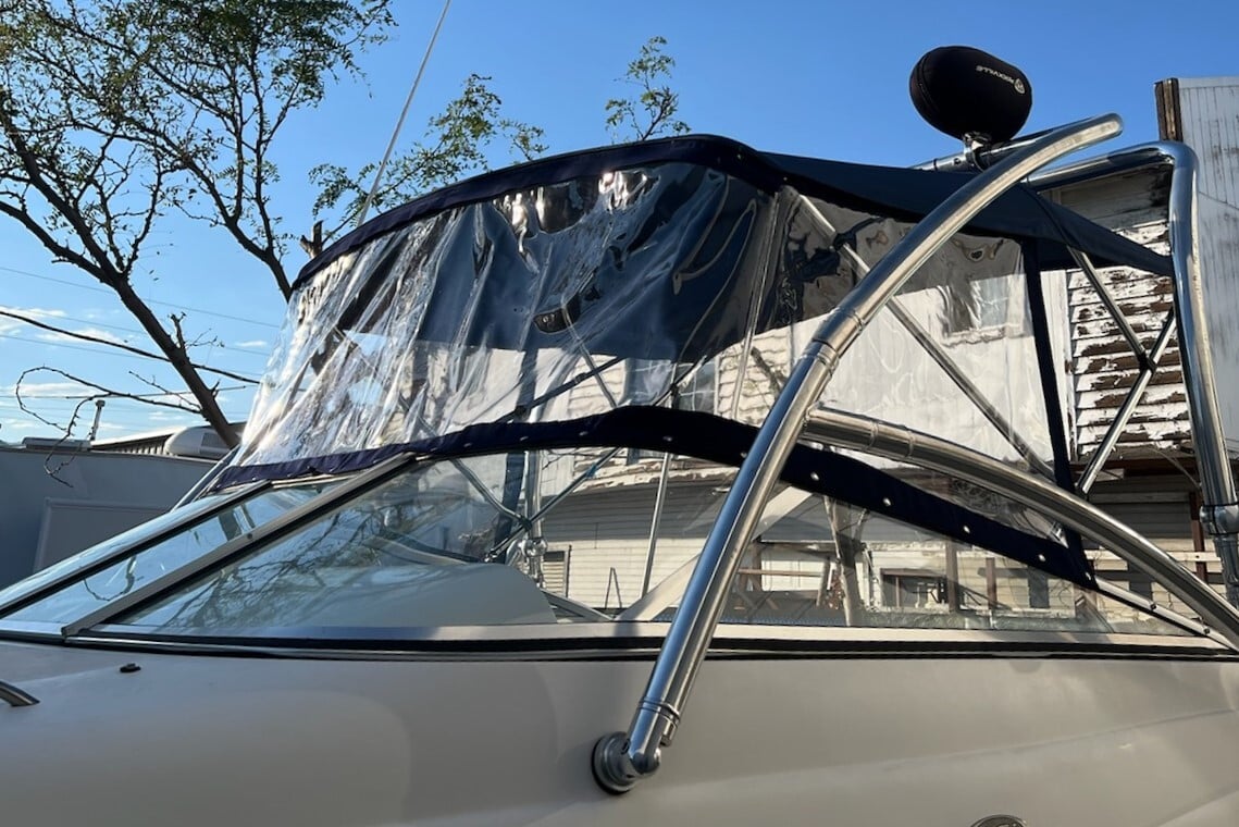 Full boat enclosure featuring clear plastic windows and durable canvas trim