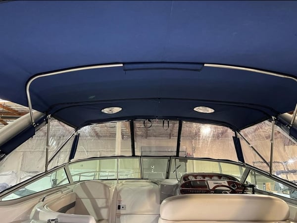 Marine-grade custom boat enclosure featuring clear plastic windows for weather protection